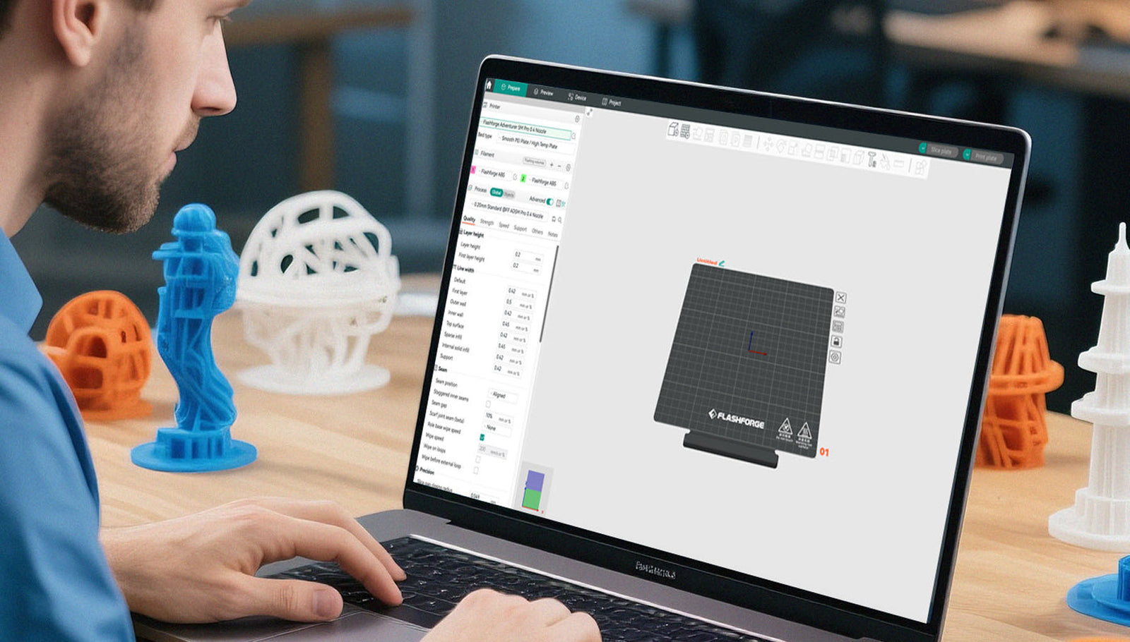 Person using a laptop with Flashforge Orca Slicer 3D printing software on a desk with 3D models.
